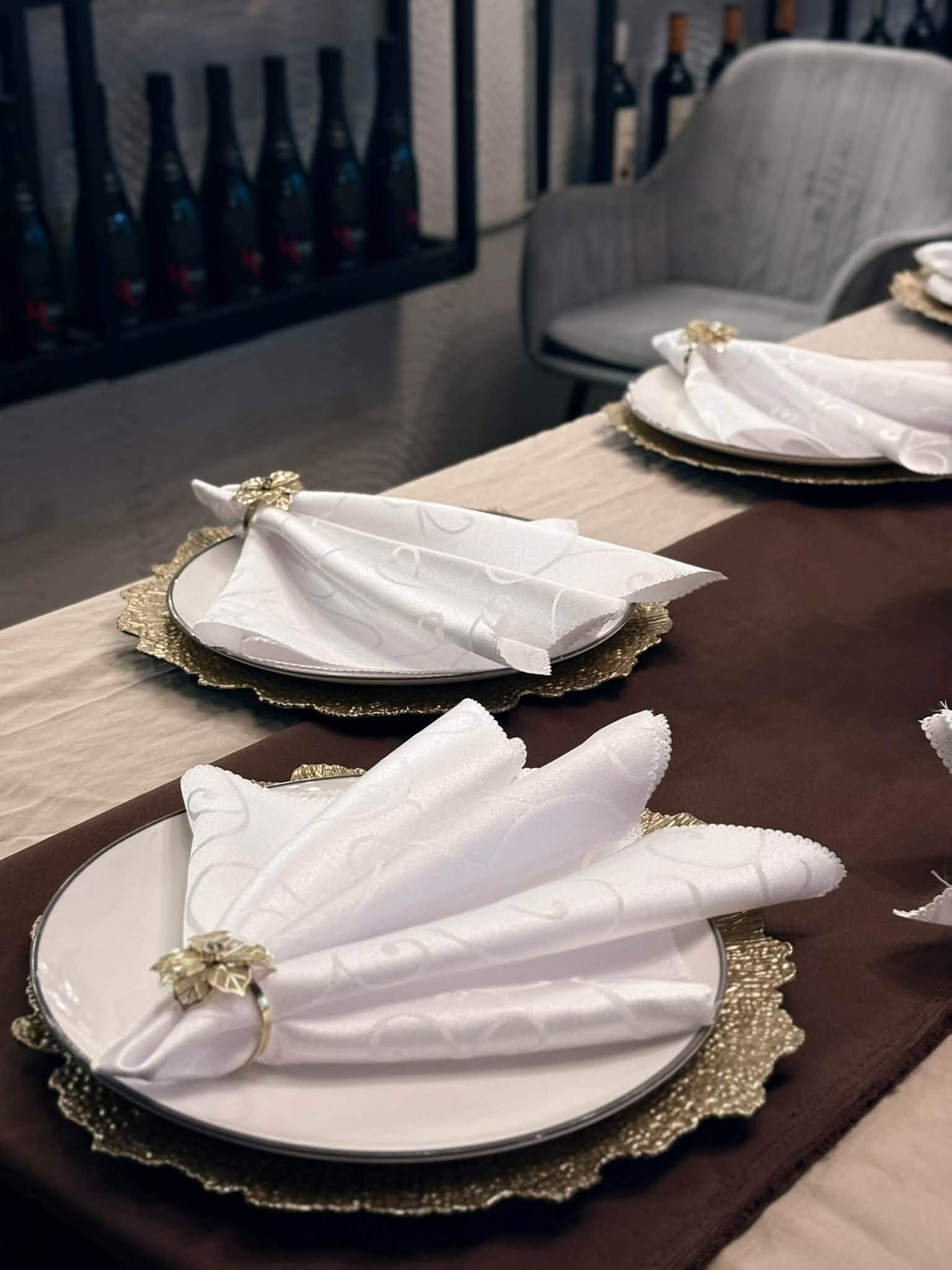Close-up of a folded napkin on a plate with a gold charger